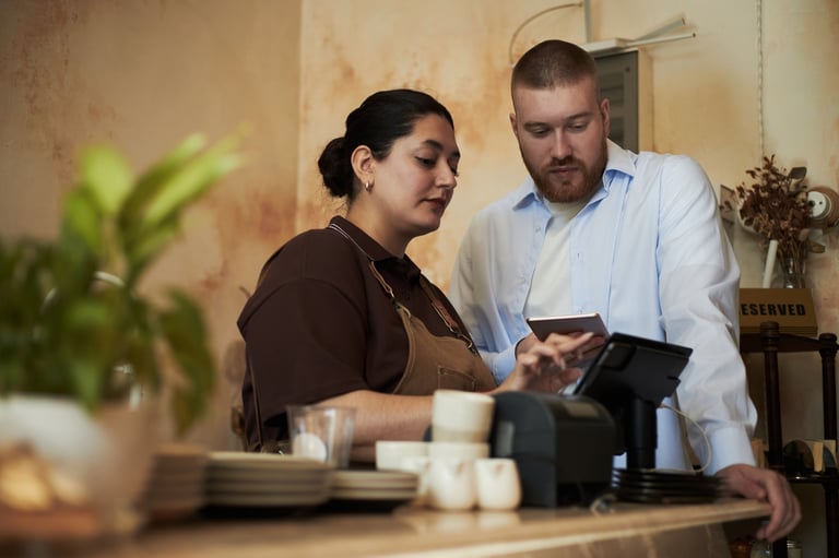 Staff using touchscreen point of sale terminal